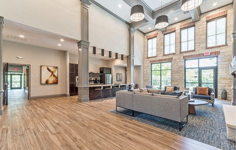 a large living room with couches and chairs and a fireplace